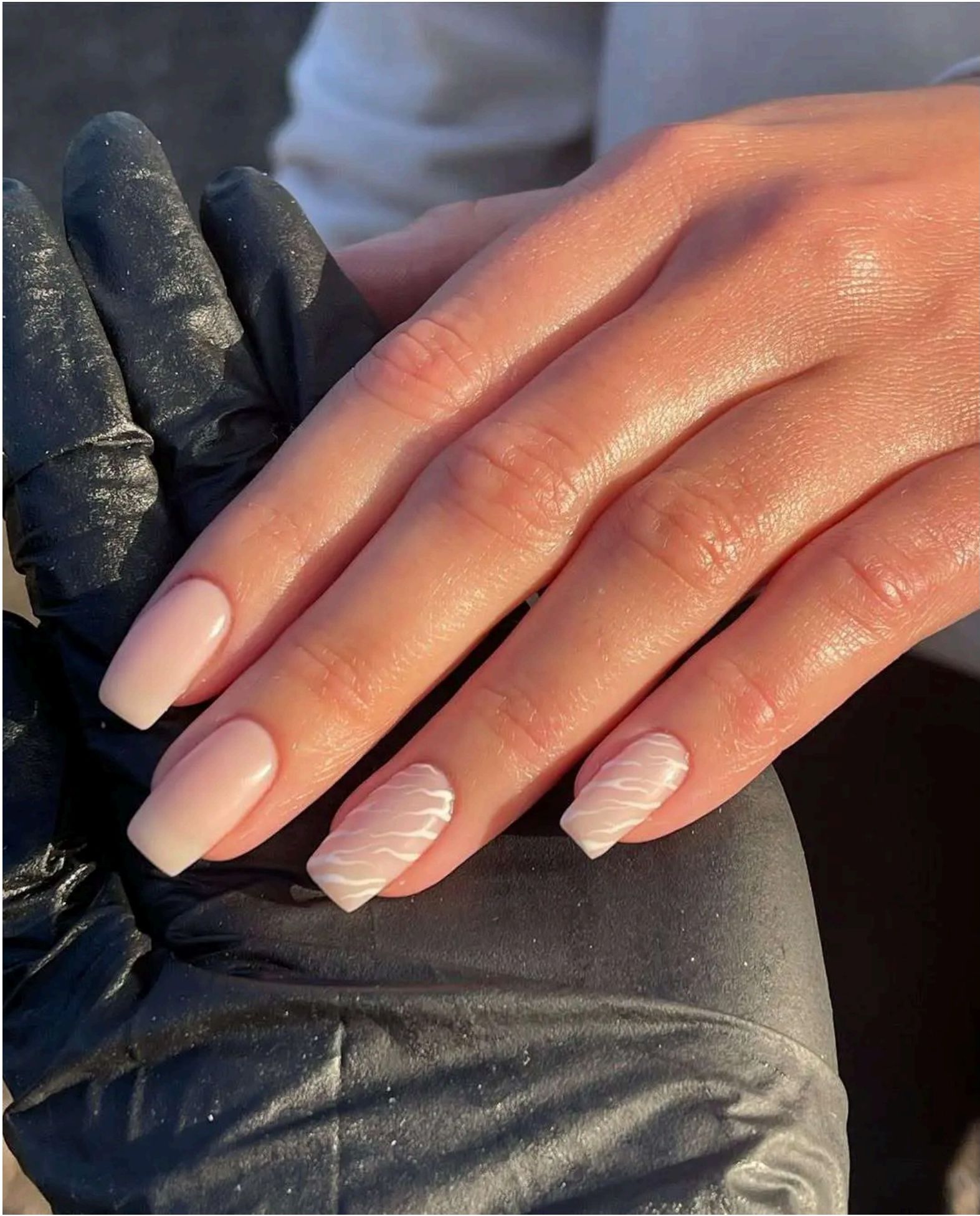 Soft nude nails with delicate white wave patterns capture that perfect ocean ripple effect.