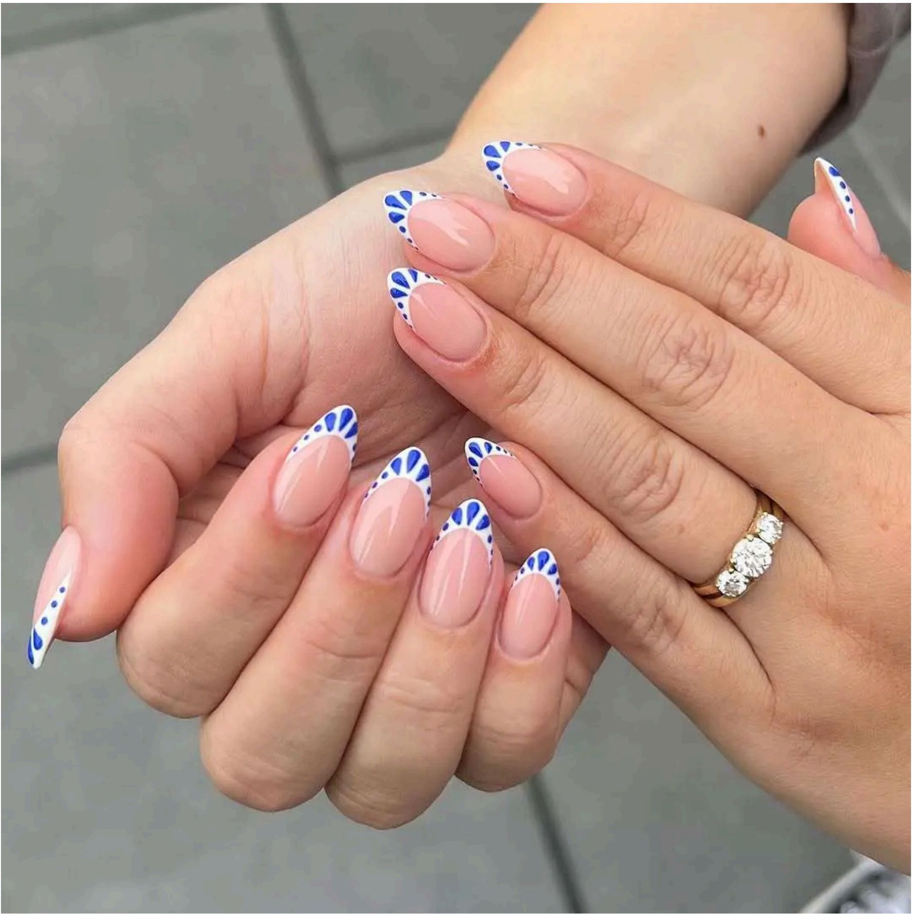Pink almond nails with Greek-inspired blue fan tips giving perfect coastal getaway vibes.
