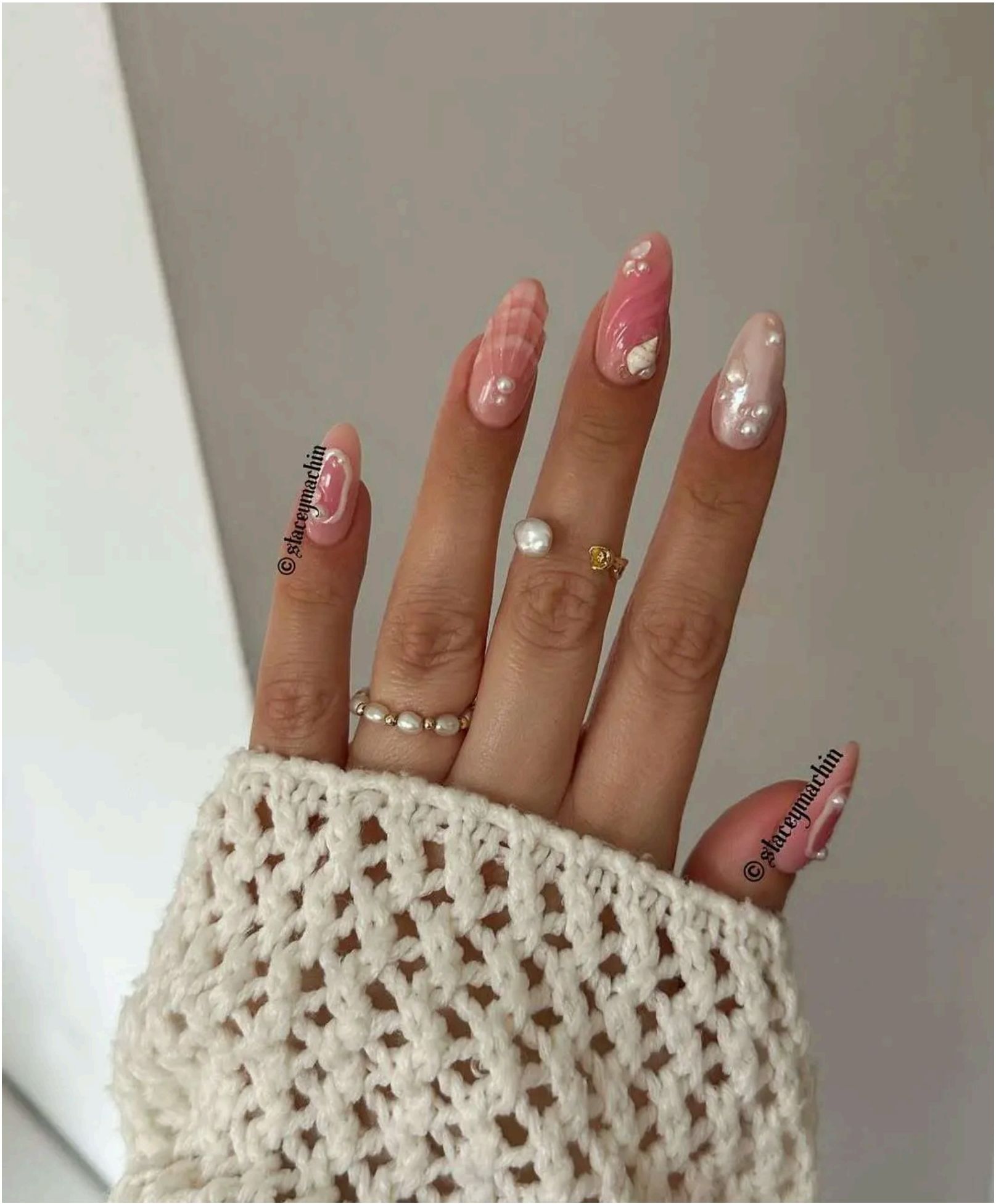 Pink gradient nails adorned with 3D shells and pearl accents make for the prettiest ocean treasures you'll find this summer.