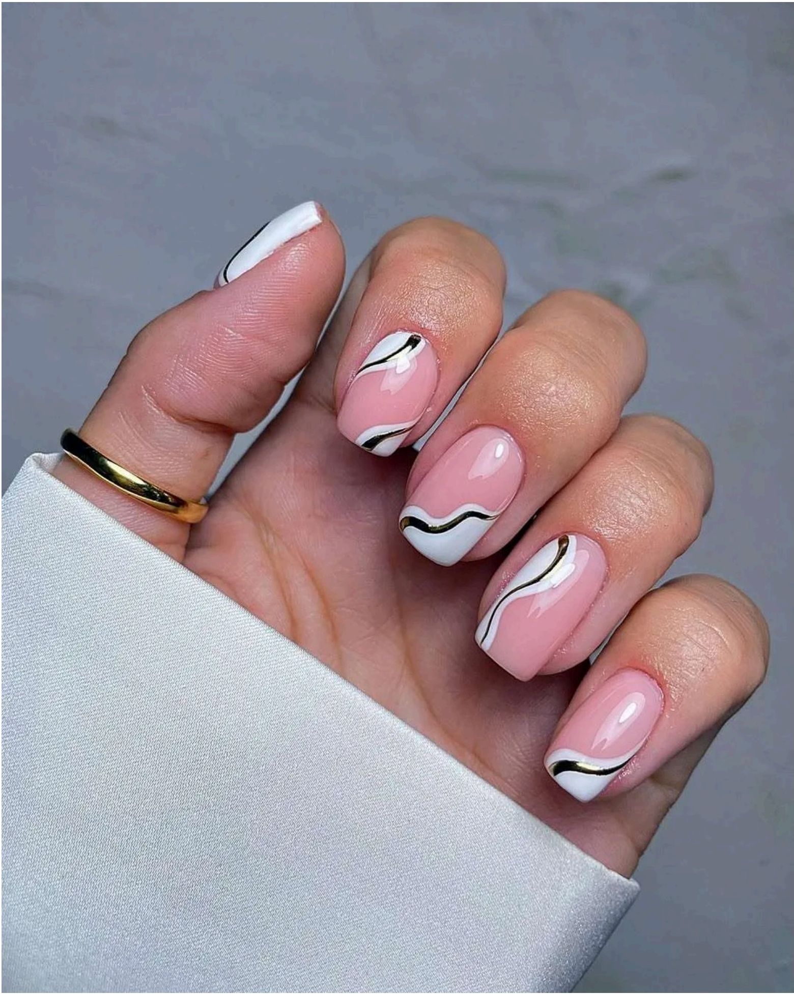 Pink base with swirling gold and white design – elegant beach ripples done right.